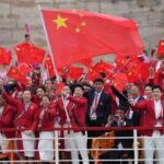 Chinese_Delegation_Shines_in_Red_at_Paris_Olympics_Opening_Ceremony