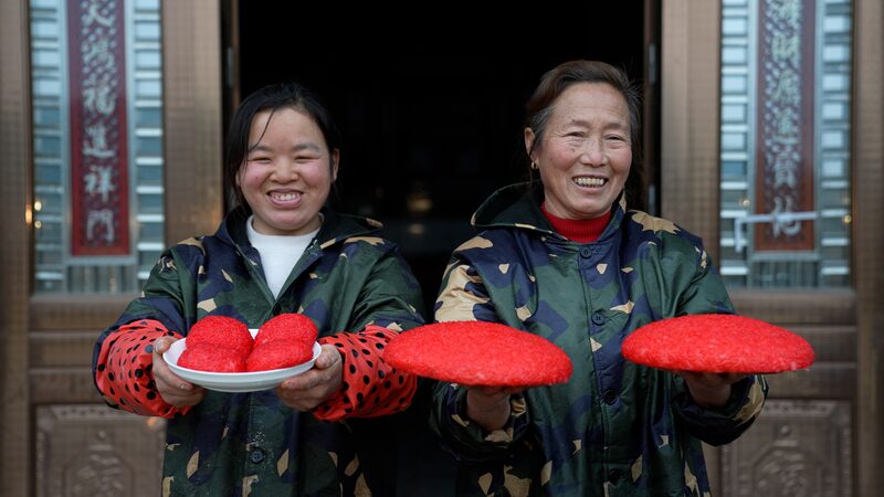 Dong_People_Craft_Festive_Hongba_Rice_Cakes_for_Chinese_New_Year_Celebrations