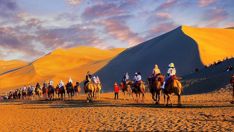 Embark on a Camel Ride Across Mingsha Mountain in China's Gansu Province video poster
