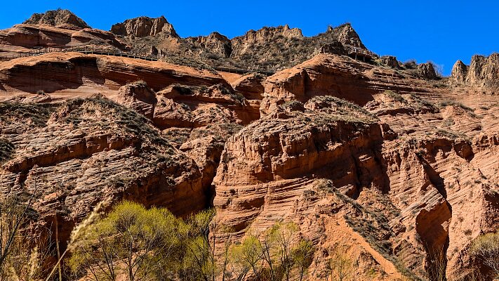 Longzhou_Danxia_Chinas_Reddish_Sandstone_Marvel_Stuns_Visitors - Khabar Asia Longzhou Danxia: China's Reddish Sandstone Marvel Stuns Visitors