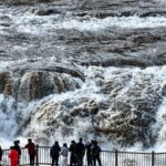 Tourists Marvel at the Winter Splendor of Hukou Waterfall