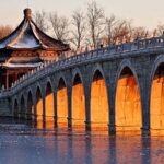 Winter Solstice Spectacle: Golden Sunlight Illuminates Summer Palace's Seventeen-Arch Bridge